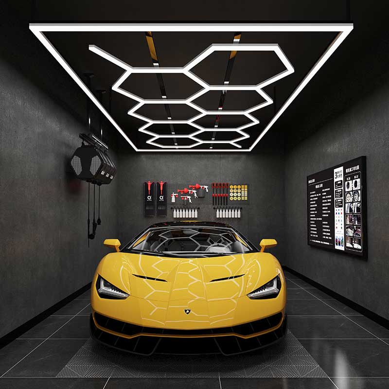 What measures do car detailers take to minimize shadows and glare in their workshop?